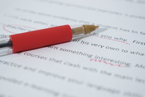 A close up of a document being edited with red ink