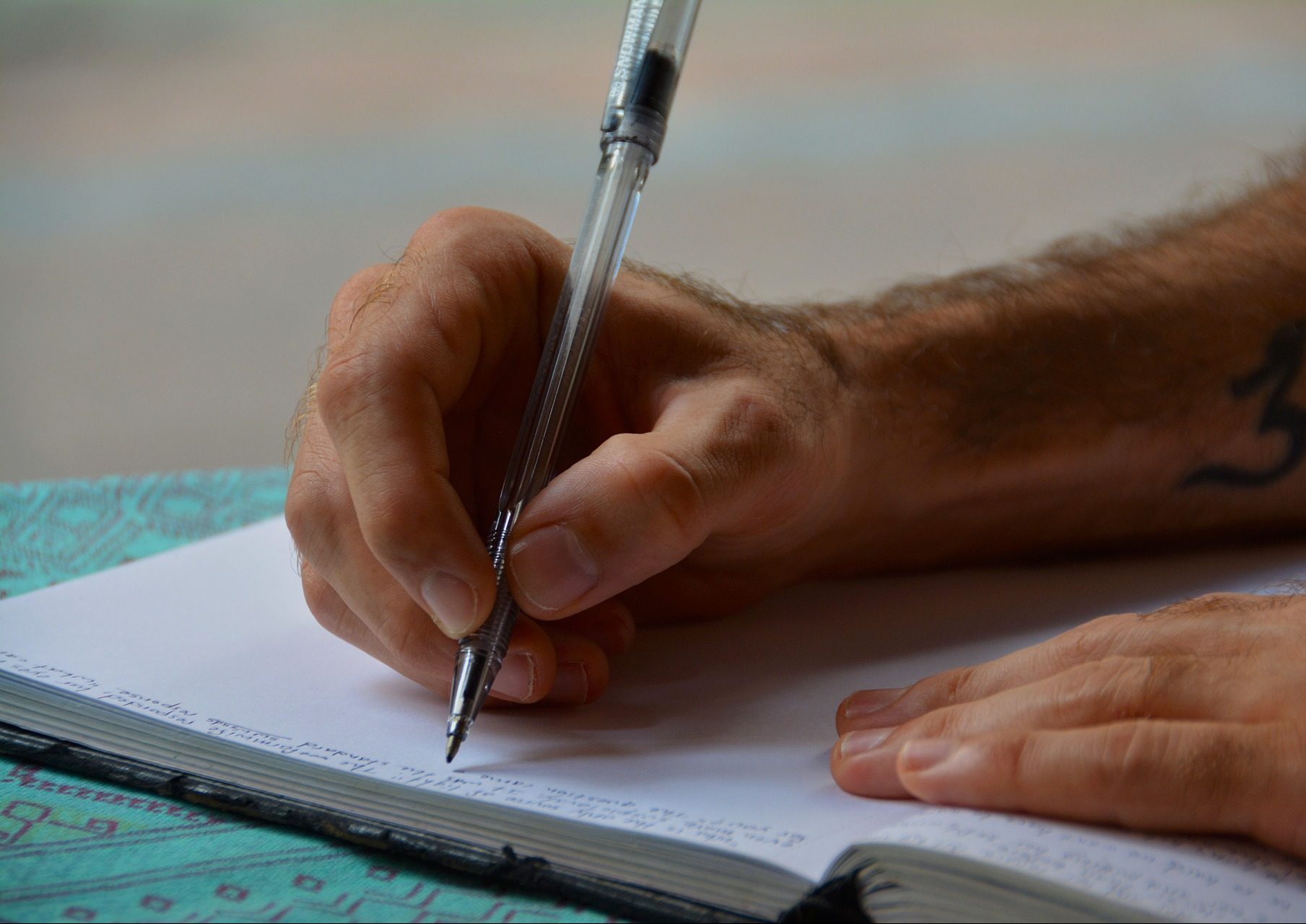 A man writing in a journal.