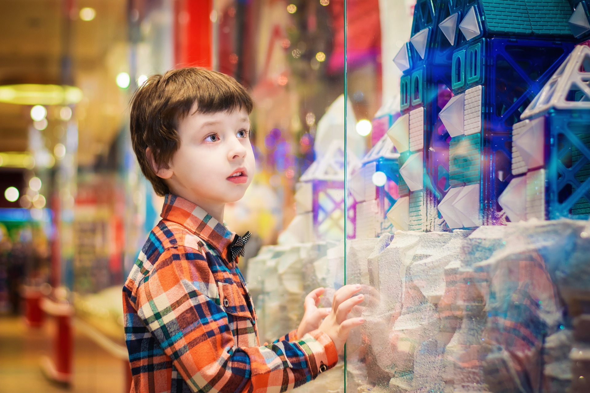 A child looking longingly through a store window