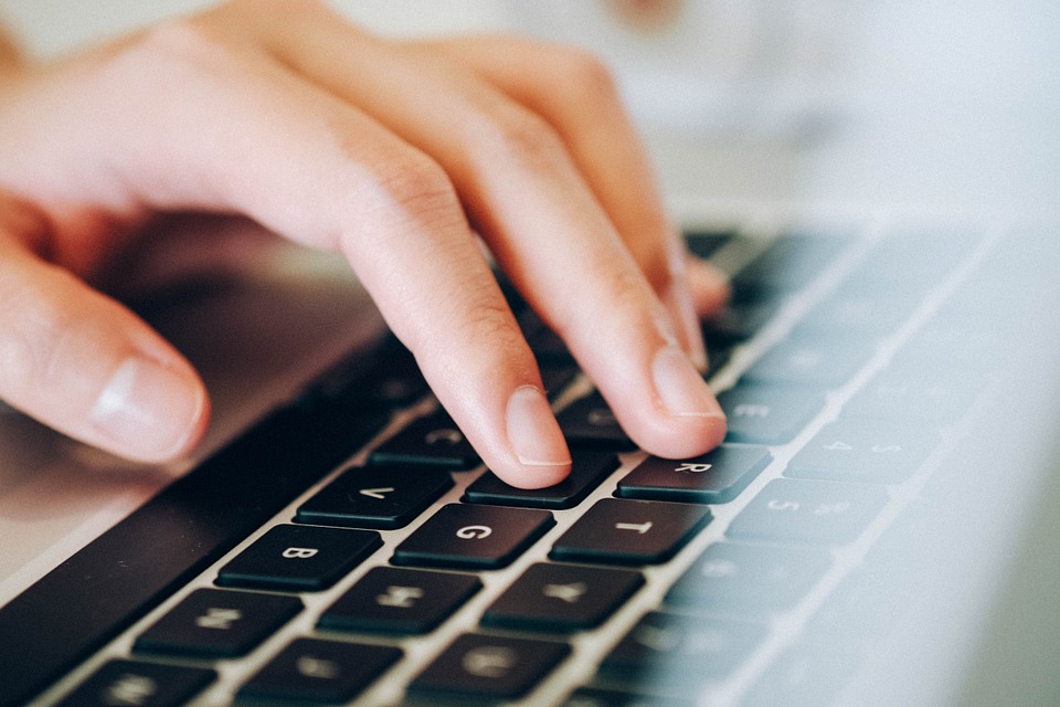 A close up of a hand on a keyboard