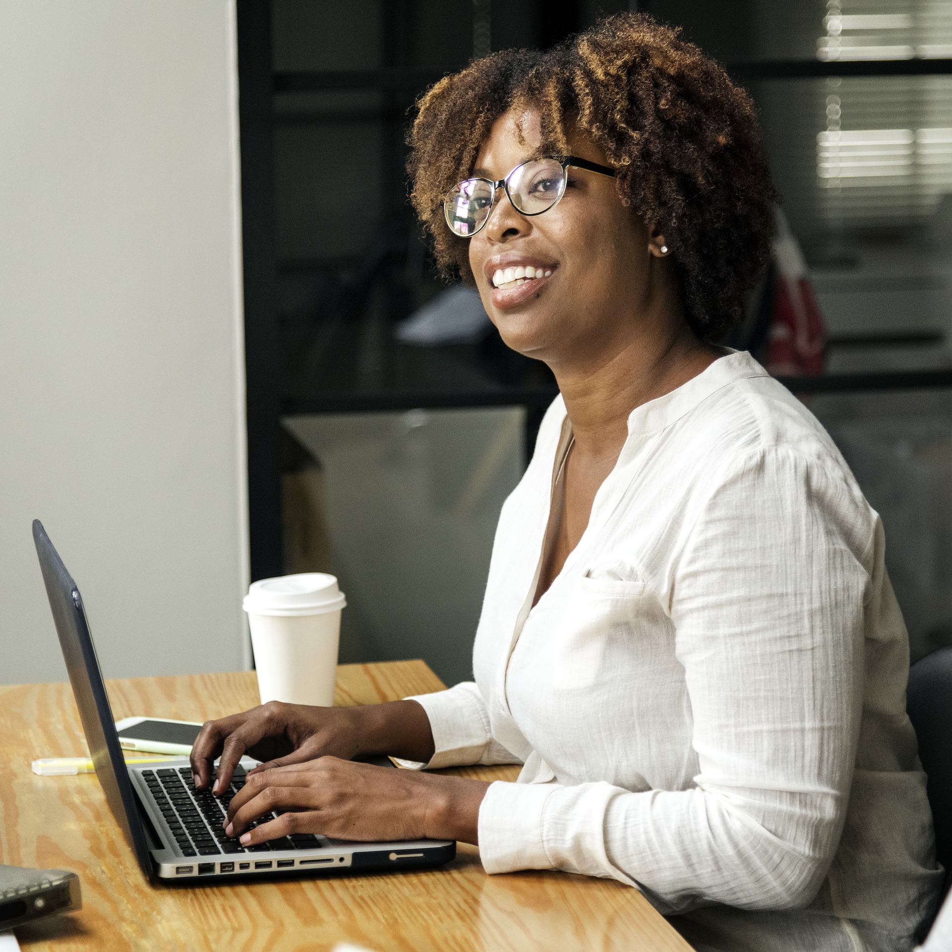 A woman typing at a computer