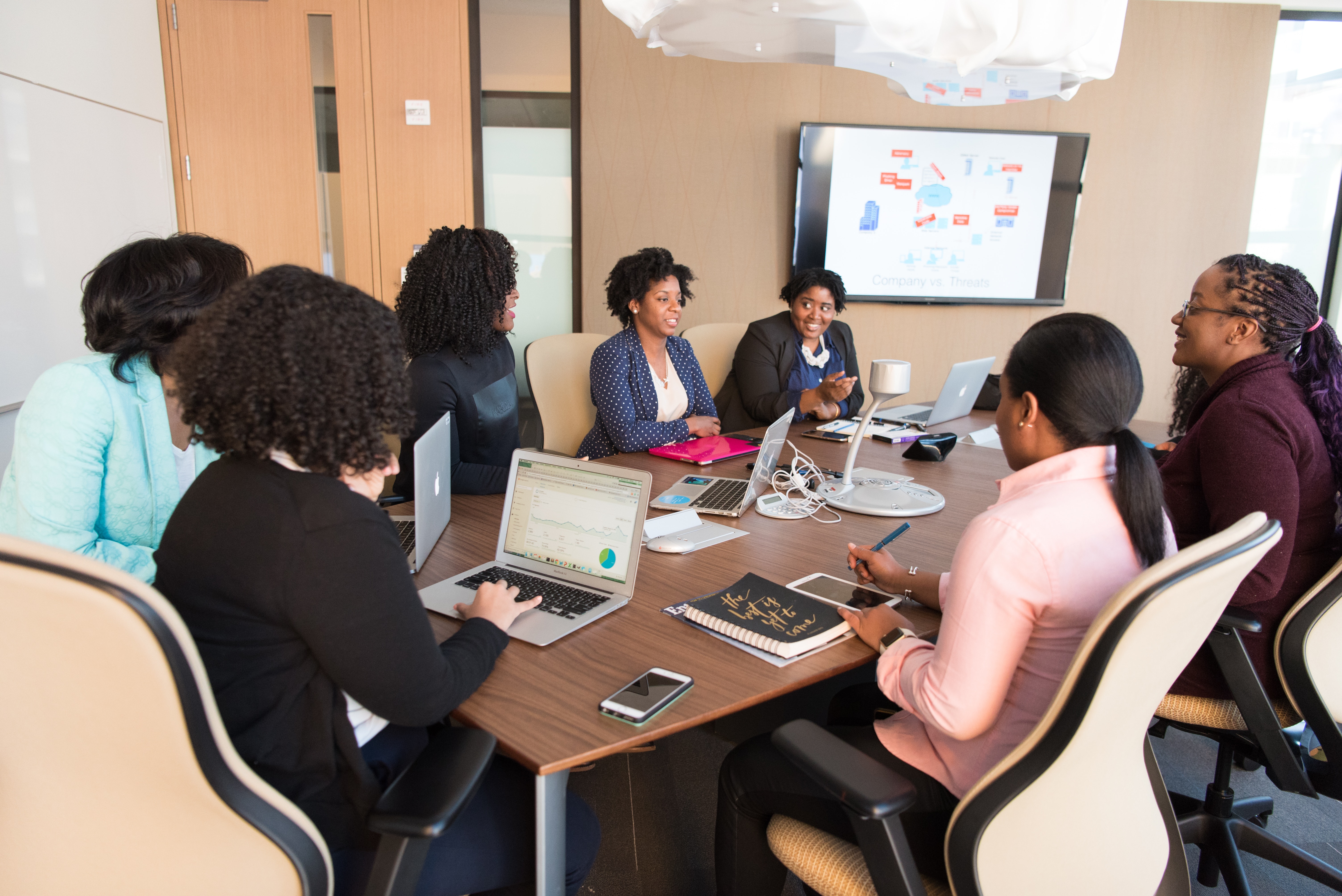 A business meeting with a presentation on the tv