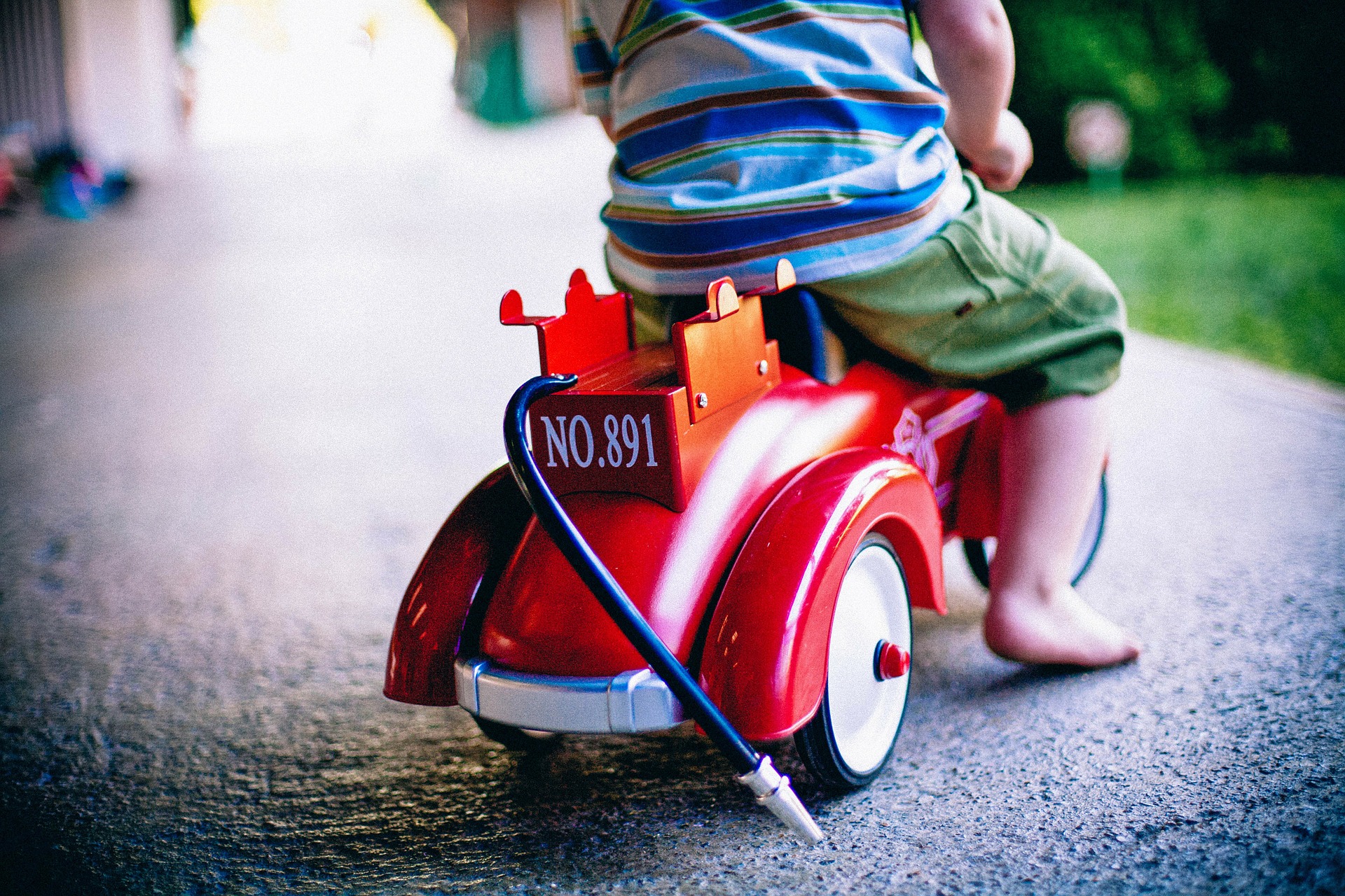 child riding toy car