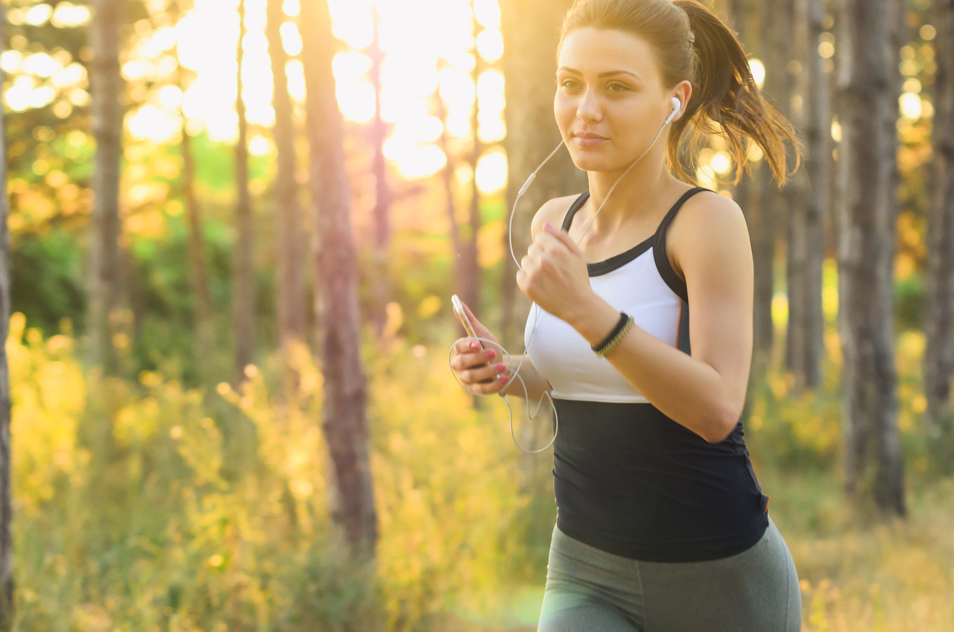 A woman jogging with headphones in