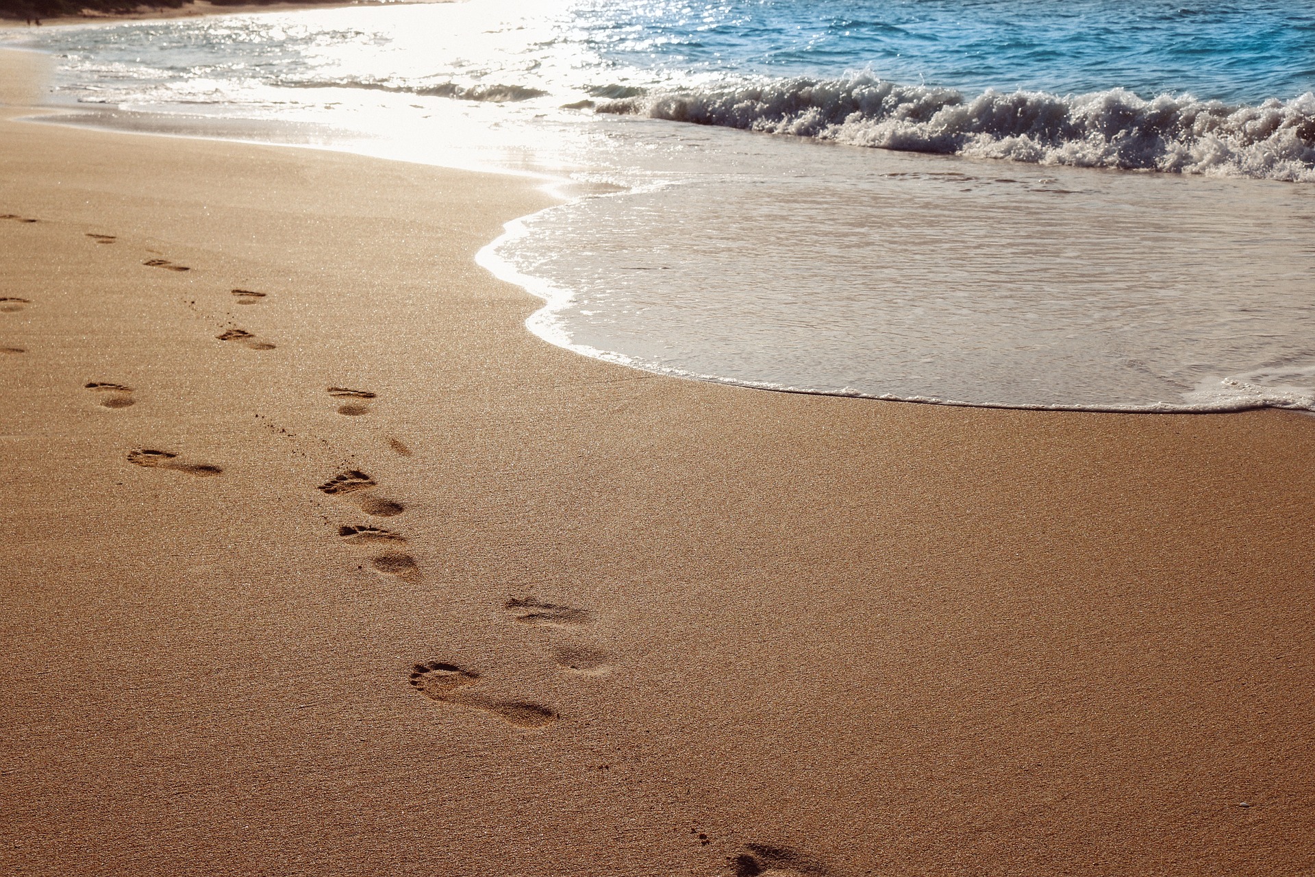 A beach with footprints in the sand