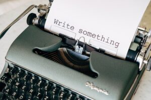 A typewriter with a page that says "write something."